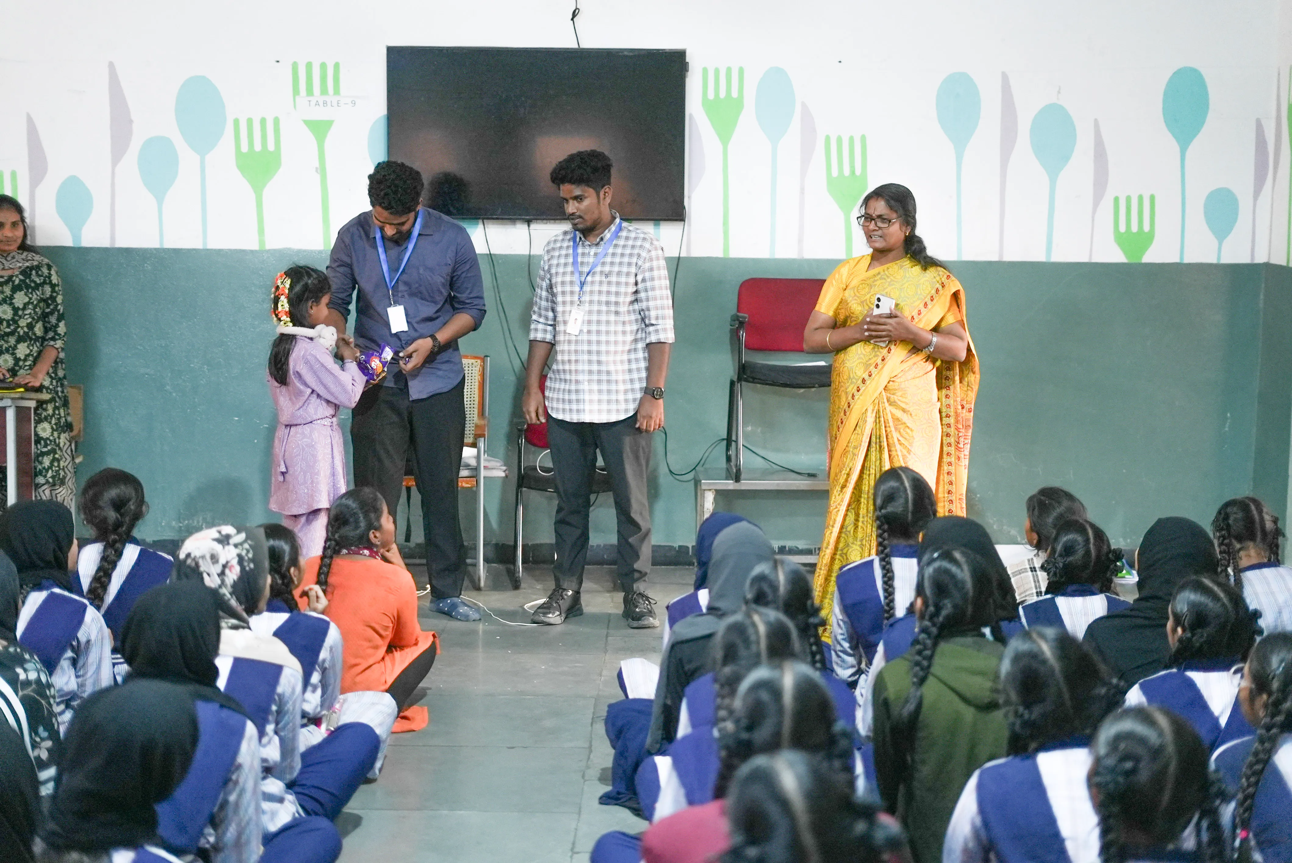 Giving chocolates to a student at the end of the session