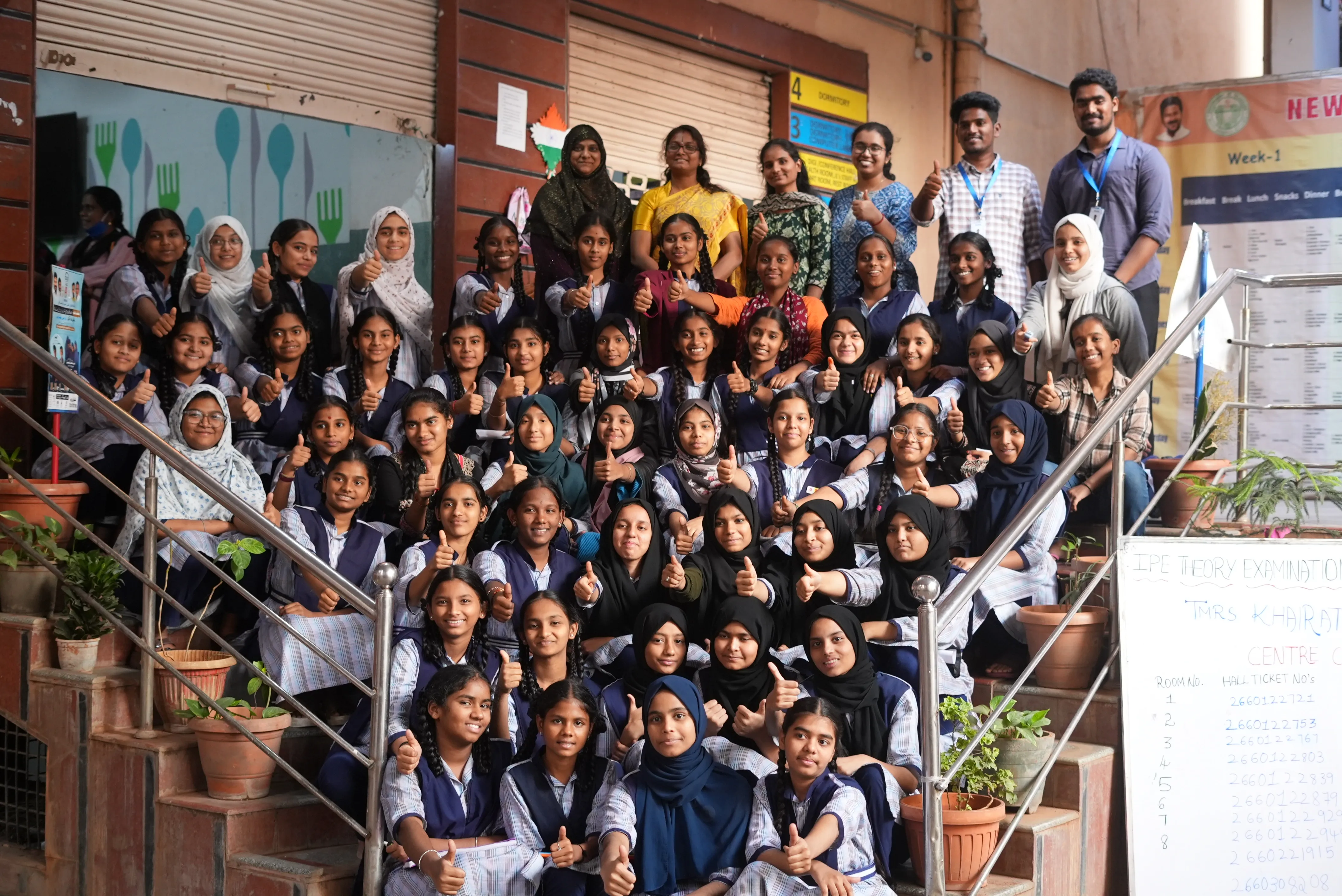 The whole school together on the steps, thumbs up after the program