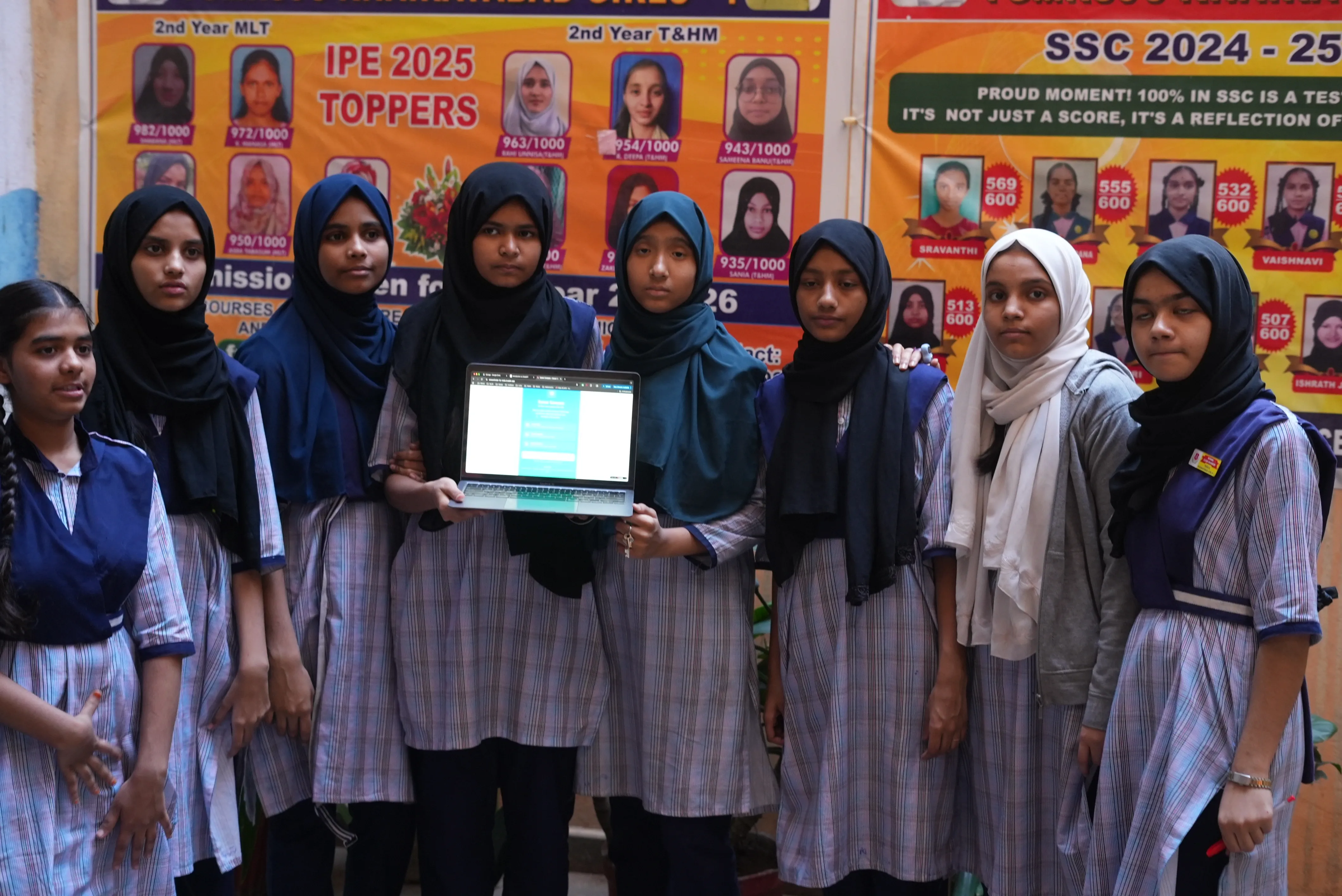 Students showing their work on a laptop